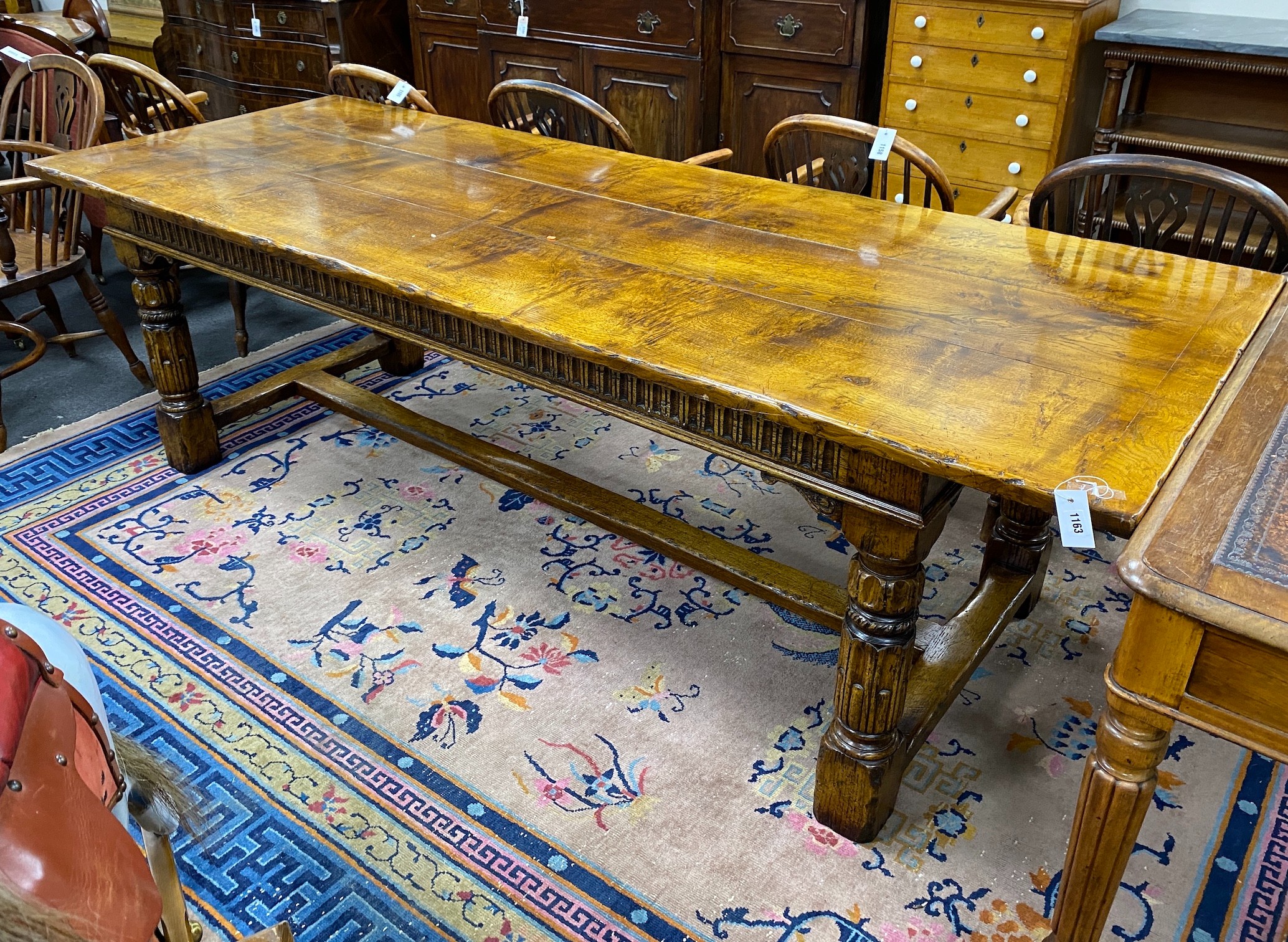 An 18th century style rectangular pale oak refectory dining table with central stretcher and two detachable extending leaves, (lacking three bolts) length 244cm, width 91cm, height 75cm, extending leaves each 46cm